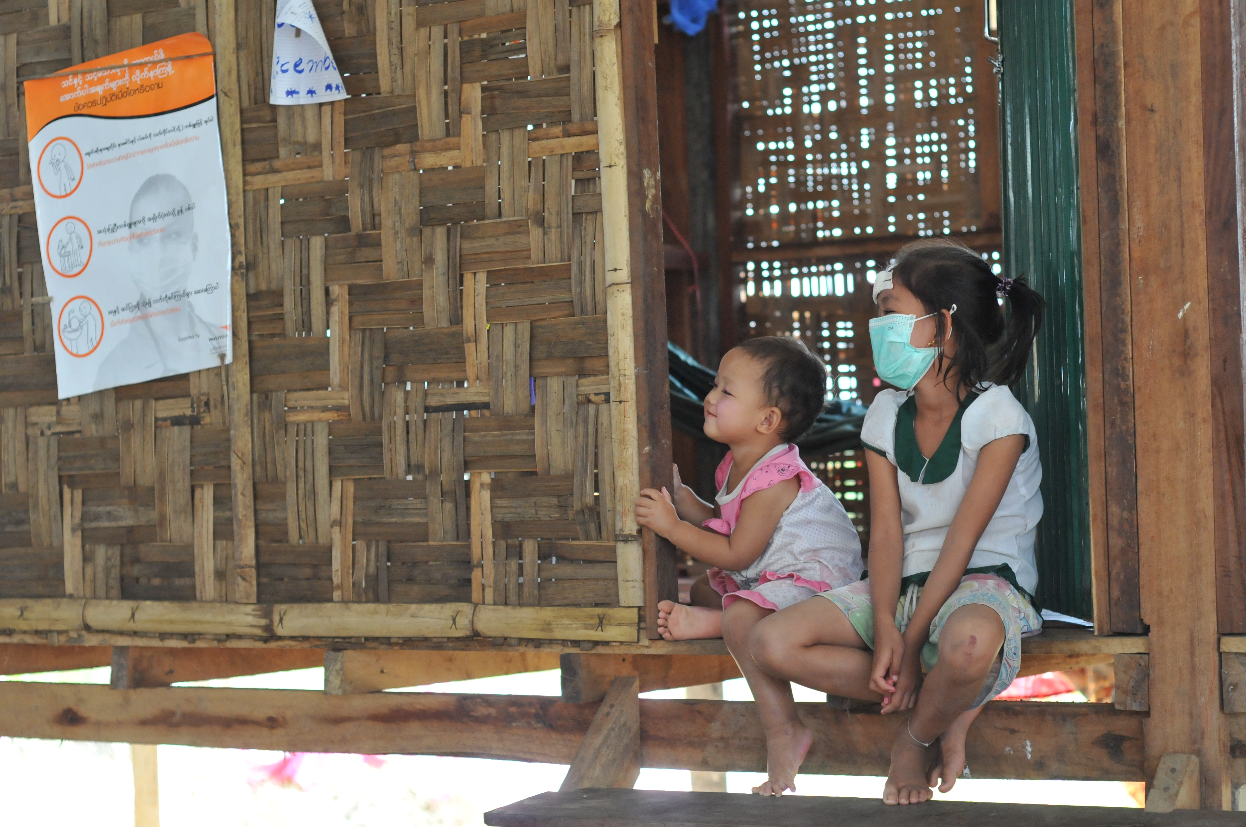 children sitting on doorstep