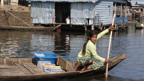 Woman rowing boat, cambodia