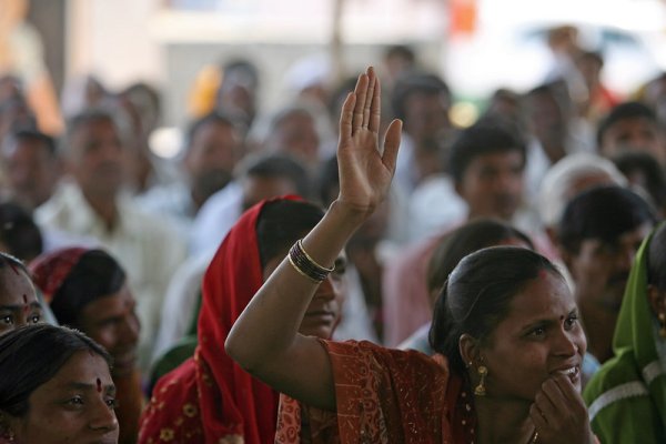 Photo of Indian women, one with her hand raised